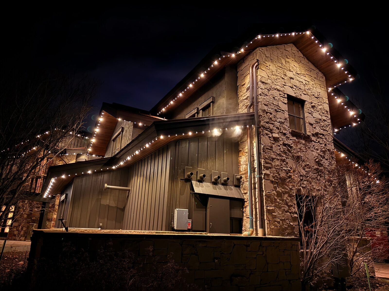 Home patio lit up with multicolor permanent lighting at night